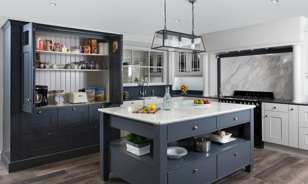 Design ideas for a mid-sized transitional l-shaped eat-in kitchen in Other with a farmhouse sink, beaded inset cabinets, grey cabinets, marble benchtops, grey splashback, marble splashback, black appliances, medium hardwood floors and with island.
