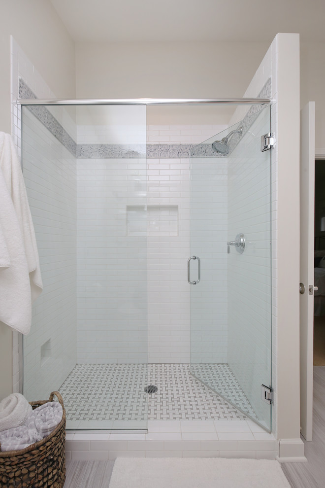 Inspiration for a small traditional 3/4 bathroom in Grand Rapids with shaker cabinets, white cabinets, a corner shower, white tile, ceramic tile, an undermount sink and engineered quartz benchtops.