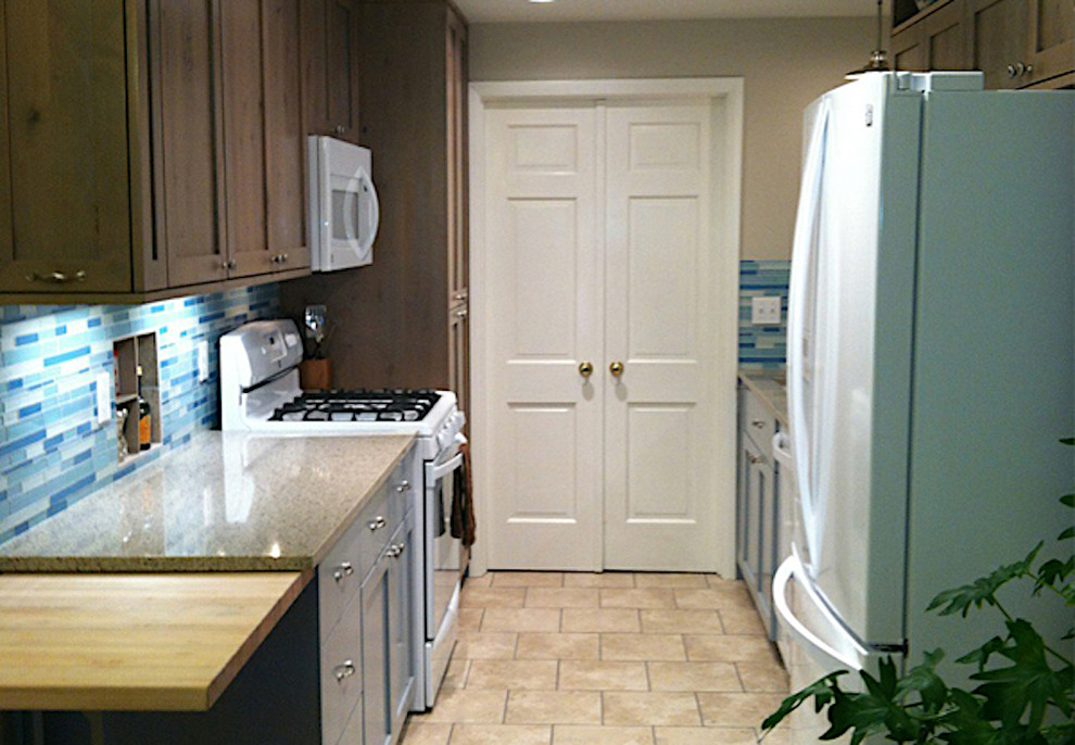 Enclosed kitchen - small transitional galley porcelain tile and beige floor enclosed kitchen idea in Boise with shaker cabinets, dark wood cabinets, quartz countertops, blue backsplash, matchstick tile backsplash, white appliances, no island, brown countertops and an undermount sink