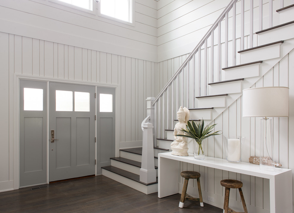 Photo of a beach style entryway in New York with white walls, dark hardwood floors, a single front door and a gray front door.