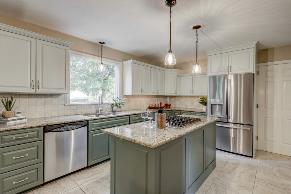 Eat-in kitchen - mid-sized transitional l-shaped ceramic tile and beige floor eat-in kitchen idea with a double-bowl sink, raised-panel cabinets, green cabinets, granite countertops, beige backsplash, ceramic backsplash, stainless steel appliances, an island and beige countertops