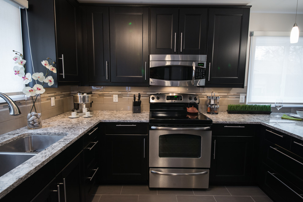 Inspiration for a transitional porcelain tile eat-in kitchen remodel in Ottawa with an undermount sink, recessed-panel cabinets, quartz countertops, glass tile backsplash and stainless steel appliances