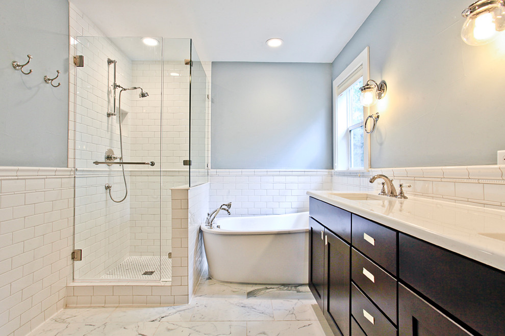 Inspiration for a small contemporary master bathroom in Denver with flat-panel cabinets, white cabinets, a freestanding tub, an alcove shower, a two-piece toilet, white tile, subway tile, blue walls, porcelain floors, an undermount sink and laminate benchtops.