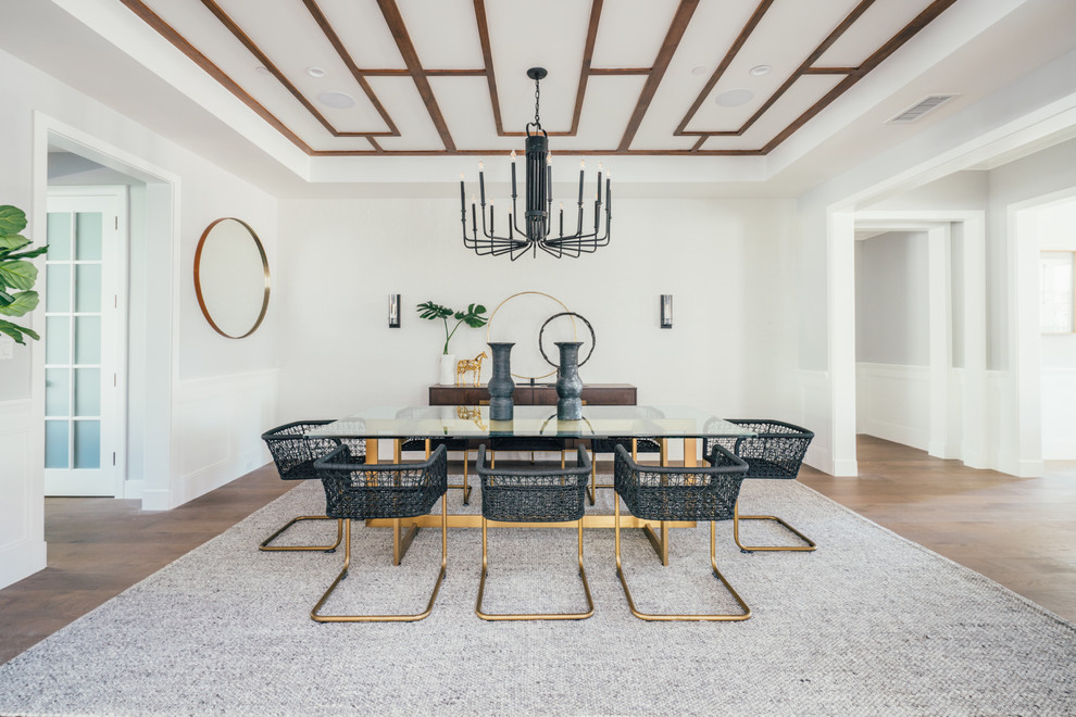 This is an example of a beach style dining room in Los Angeles with white walls, no fireplace and medium hardwood floors.