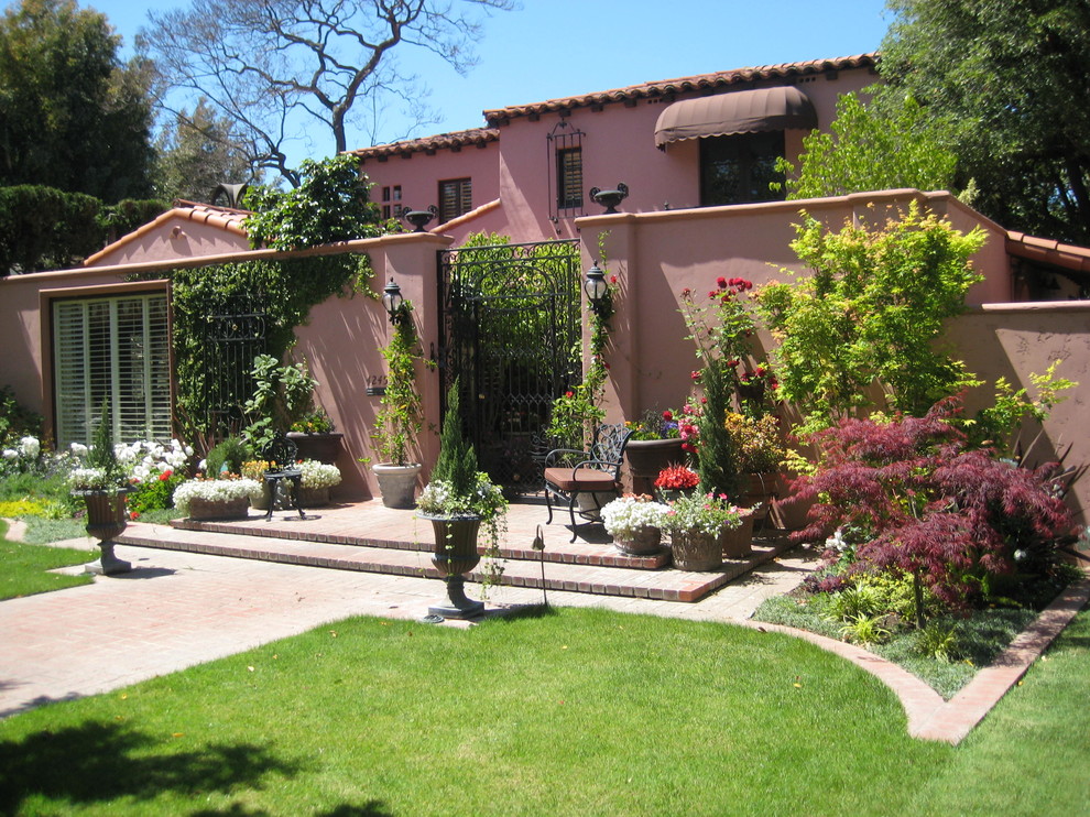 Photo of a mediterranean pink exterior in Los Angeles.