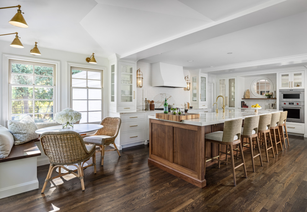 Eat-in kitchen - transitional l-shaped dark wood floor eat-in kitchen idea with a drop-in sink, shaker cabinets, white cabinets, marble countertops, marble backsplash, paneled appliances, an island and gray countertops