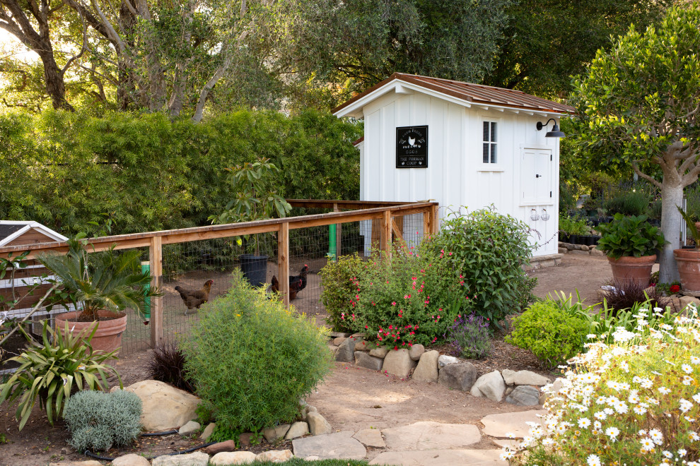 Inspiration for a farmhouse partial sun garden in Santa Barbara with a wood fence.