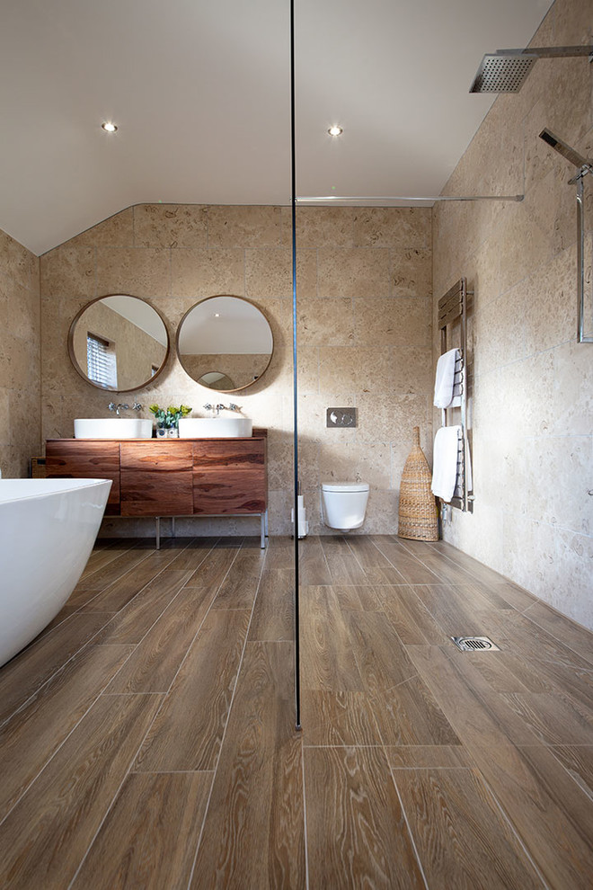 Photo of a beach style bathroom in Other with limestone and porcelain floors.