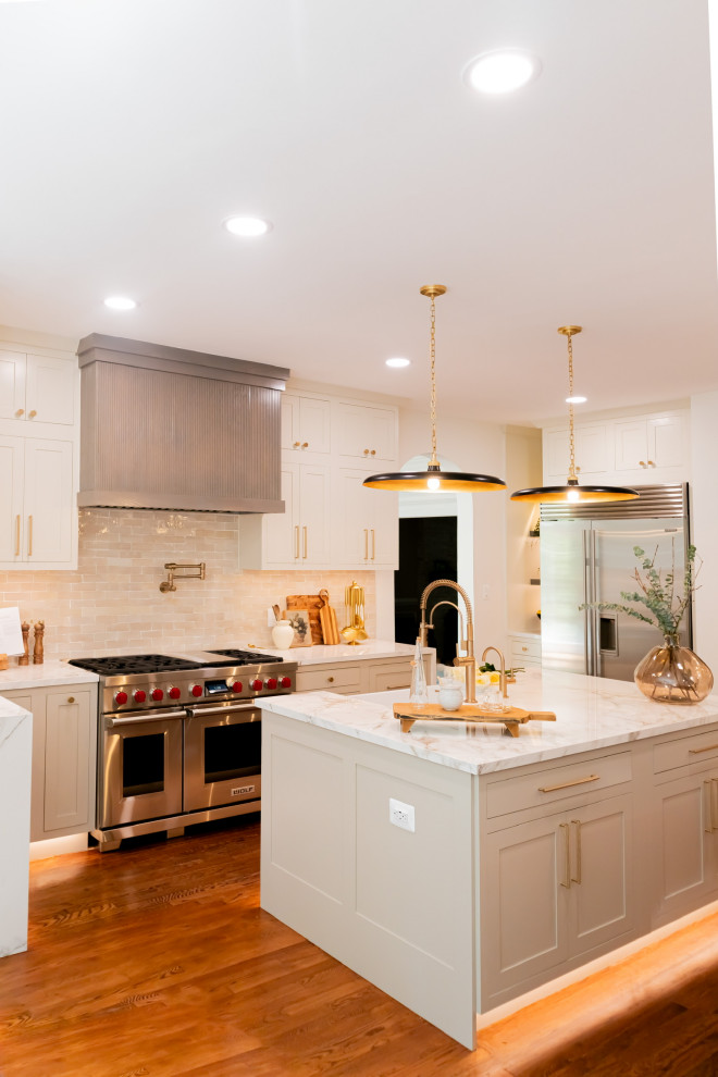 Large transitional u-shaped eat-in kitchen in DC Metro with a farmhouse sink, beaded inset cabinets, beige cabinets, ceramic splashback, stainless steel appliances and multiple islands.