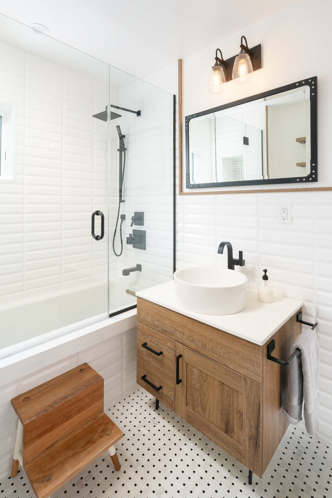 Mid-sized scandinavian bathroom in New York with medium wood cabinets, a shower/bathtub combo, a wall-mount toilet, white tile, porcelain tile, white walls, porcelain floors, a vessel sink, engineered quartz benchtops, a hinged shower door, white benchtops, a niche, a single vanity and a freestanding vanity.