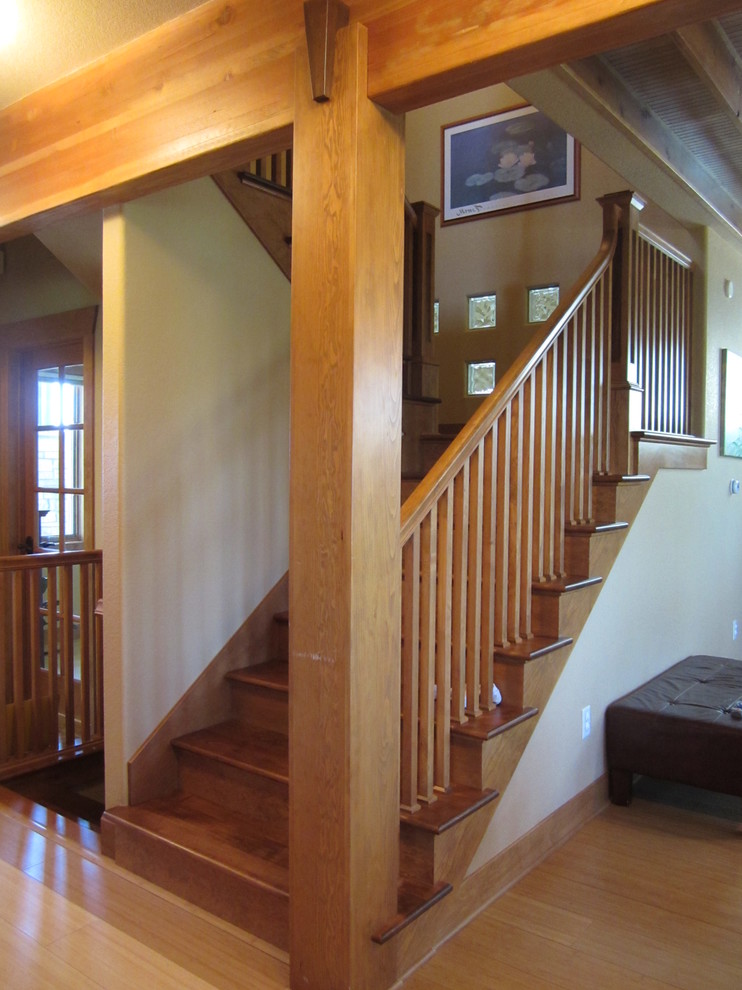 This is an example of a mid-sized arts and crafts wood u-shaped staircase in Denver with wood risers.