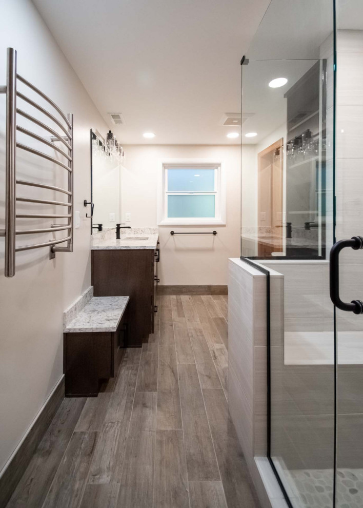 Photo of a large midcentury 3/4 bathroom in Portland with recessed-panel cabinets, dark wood cabinets, a corner shower, a two-piece toilet, gray tile, ceramic tile, grey walls, porcelain floors, an undermount sink, engineered quartz benchtops, beige floor, a hinged shower door, grey benchtops, a shower seat, a single vanity and a built-in vanity.