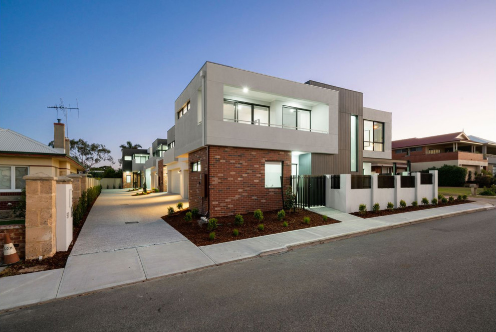 Photo of a small contemporary two-storey townhouse exterior in Perth with concrete fiberboard siding and a metal roof.