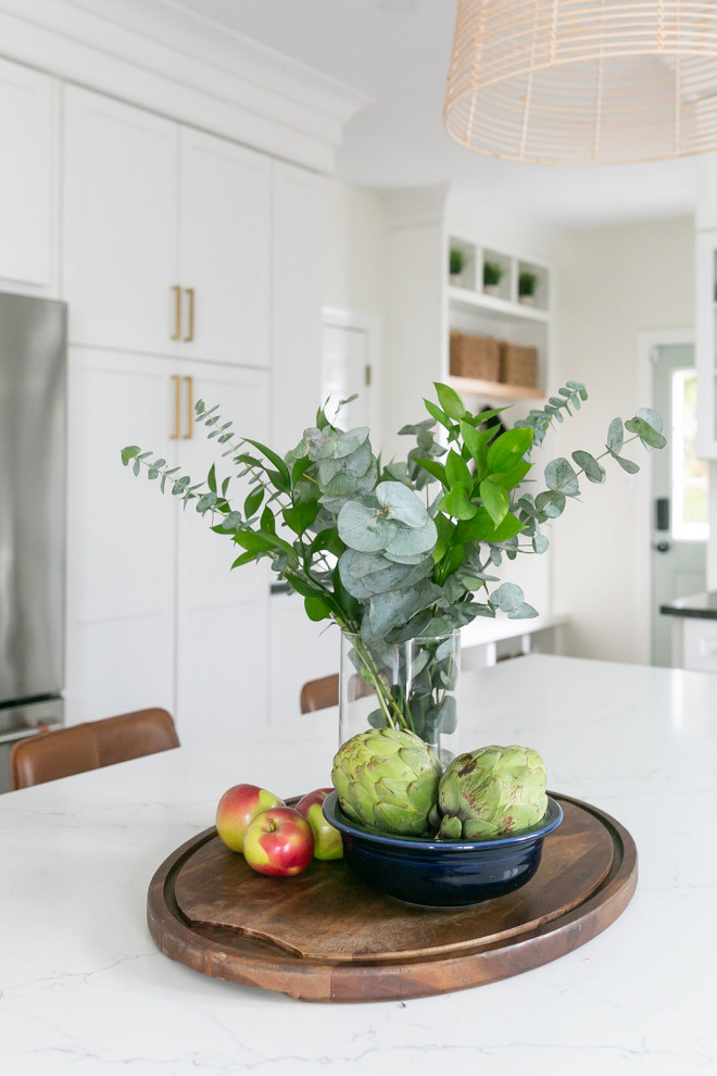 Kitchen pantry - large transitional l-shaped brown floor kitchen pantry idea in Baltimore with a drop-in sink, shaker cabinets, white cabinets, quartz countertops, white backsplash, ceramic backsplash, stainless steel appliances, an island and white countertops