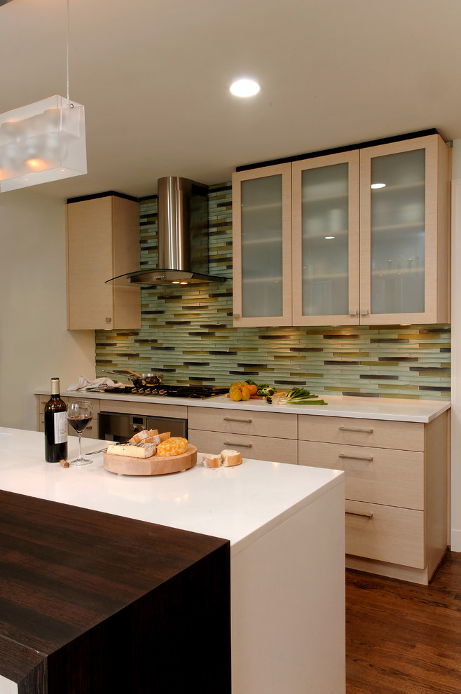 Design ideas for a mid-sized contemporary l-shaped eat-in kitchen in DC Metro with a drop-in sink, flat-panel cabinets, beige cabinets, quartz benchtops, multi-coloured splashback, mosaic tile splashback, stainless steel appliances, medium hardwood floors, with island and brown floor.