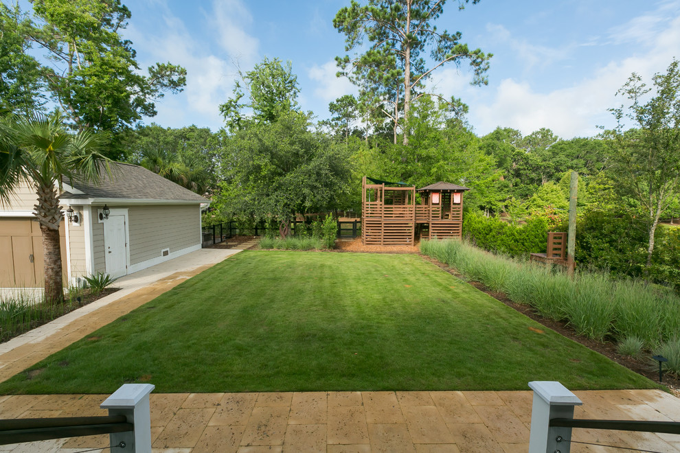 Photo of a contemporary backyard garden in Charleston with with outdoor playset.