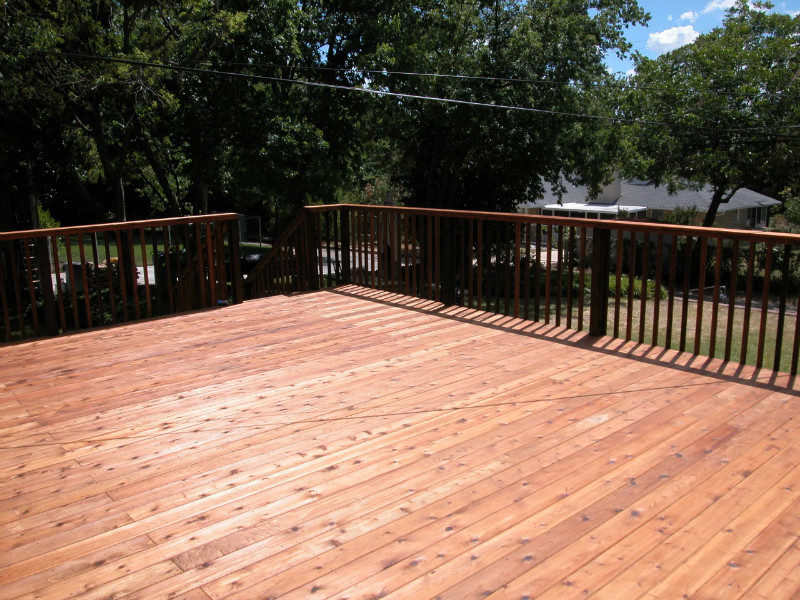 Example of a large transitional backyard deck design in Dallas with no cover