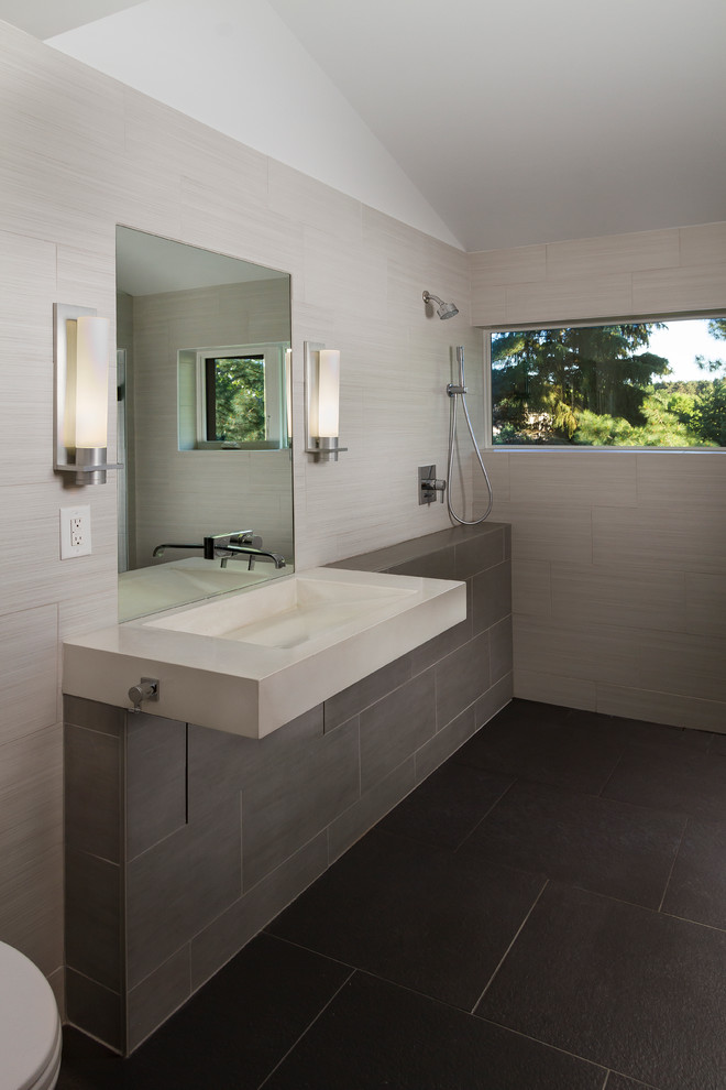 Photo of a mid-sized contemporary 3/4 wet room bathroom in Minneapolis with flat-panel cabinets, medium wood cabinets, a wall-mount toilet, gray tile, ceramic tile, grey walls, ceramic floors and concrete benchtops.