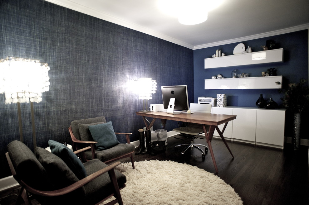 This is an example of a contemporary home office in Vancouver with blue walls, dark hardwood floors and a freestanding desk.
