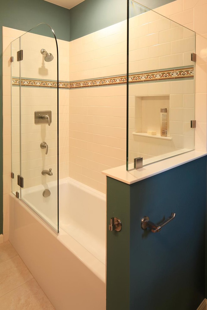 Inspiration for a small mediterranean master bathroom in San Francisco with an undermount sink, furniture-like cabinets, medium wood cabinets, solid surface benchtops, an alcove tub, a shower/bathtub combo, a two-piece toilet, beige tile, ceramic tile, green walls and ceramic floors.