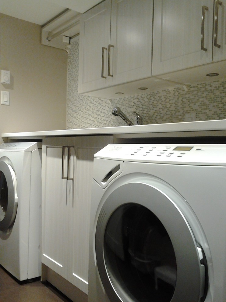 Example of a mid-sized transitional galley cork floor dedicated laundry room design in Montreal with shaker cabinets, beige cabinets, quartz countertops, a side-by-side washer/dryer, an undermount sink and beige walls