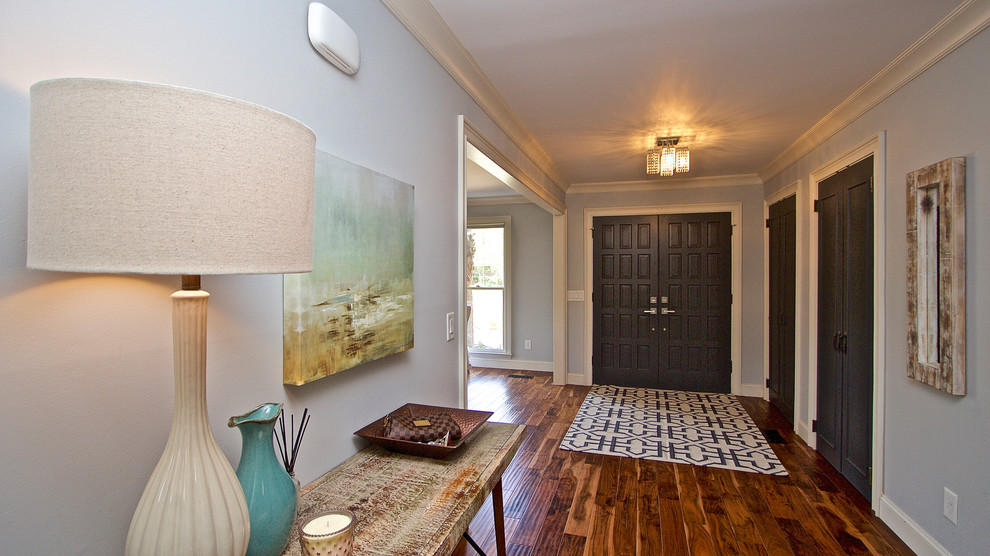 Photo of a mid-sized beach style foyer in Charleston with blue walls, medium hardwood floors, a double front door and a gray front door.