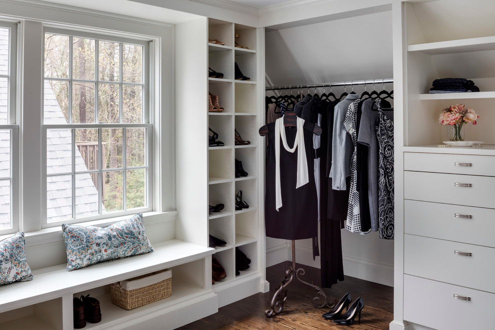 Photo of a transitional women's dressing room in Boston with open cabinets, white cabinets and medium hardwood floors.