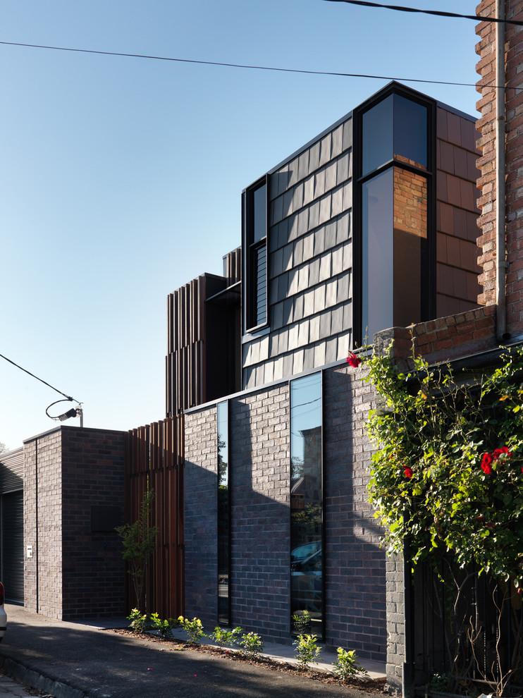 Photo of a mid-sized modern two-storey brown exterior in Melbourne with wood siding and a flat roof.