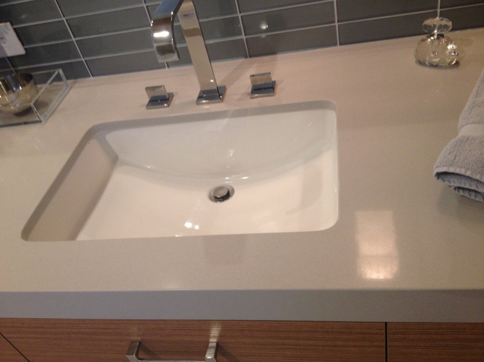Freestanding bathtub - mid-sized transitional master blue tile and subway tile light wood floor and blue floor freestanding bathtub idea with flat-panel cabinets, distressed cabinets, beige walls, an undermount sink, solid surface countertops and a hinged shower door