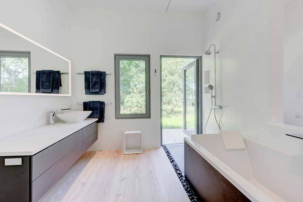 Large modern master bathroom in New York with flat-panel cabinets.