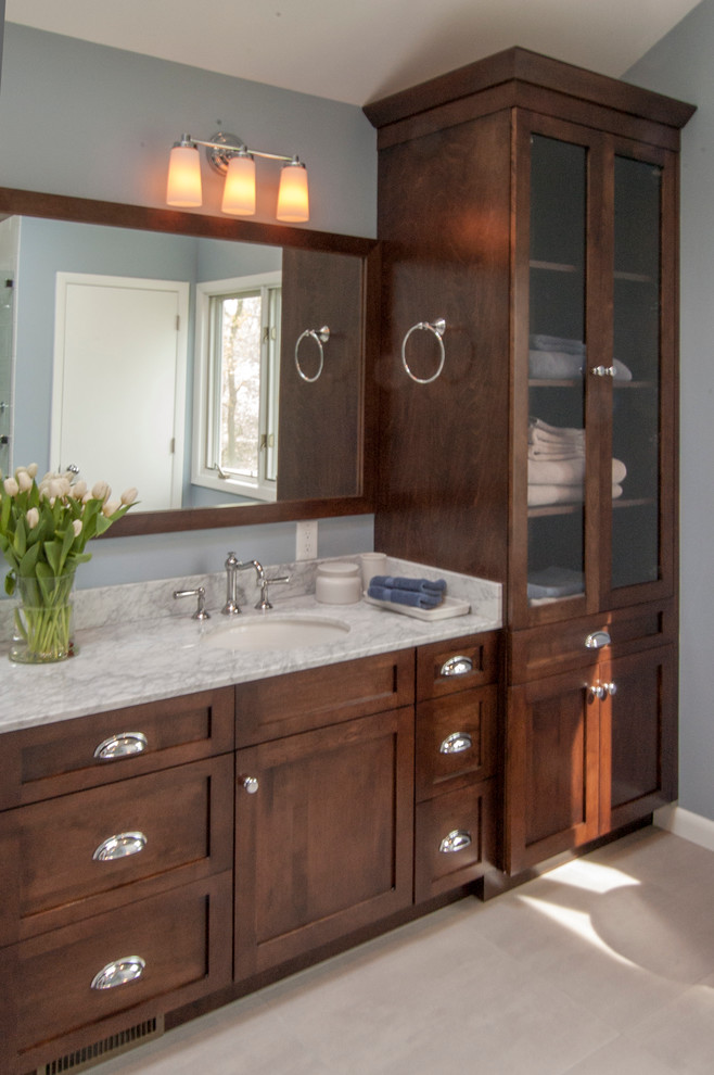 Photo of a large transitional master bathroom in Philadelphia with an undermount sink, shaker cabinets, dark wood cabinets, granite benchtops, white tile, stone tile, blue walls and porcelain floors.