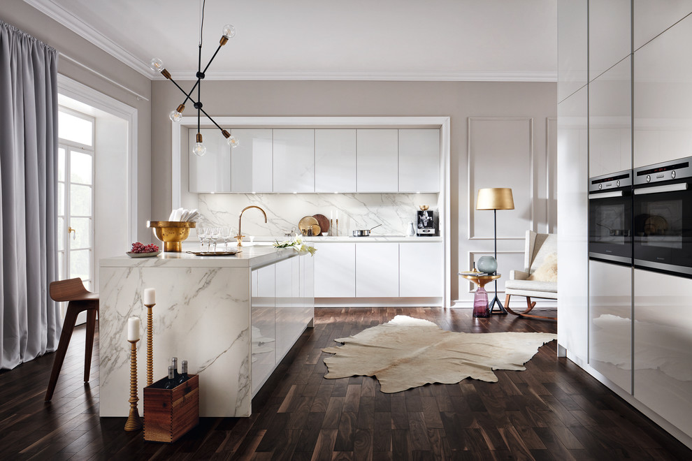 This is an example of a mid-sized contemporary eat-in kitchen in Moscow with white cabinets, white splashback, with island, flat-panel cabinets, dark hardwood floors, brown floor and stainless steel appliances.