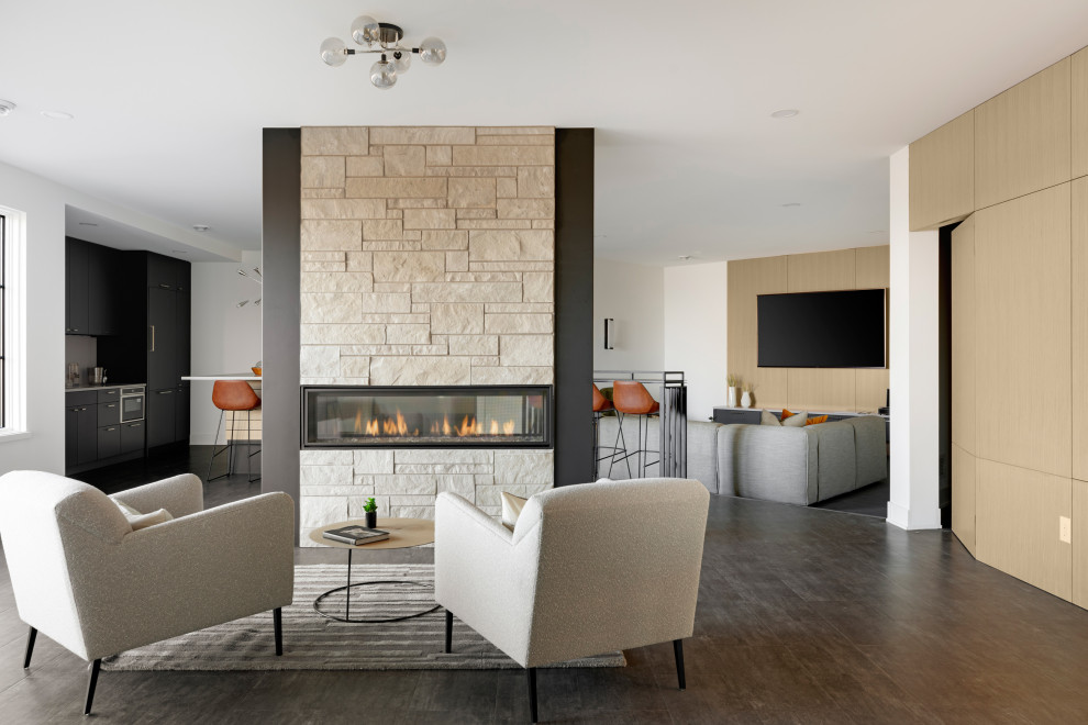 This is an example of a contemporary living room in Minneapolis with white walls, a two-sided fireplace and a stone fireplace surround.