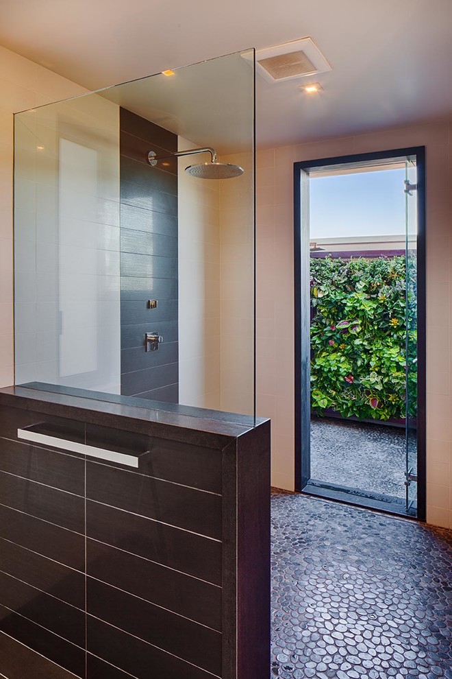 Photo of an expansive contemporary master bathroom in San Diego with an undermount sink, flat-panel cabinets, dark wood cabinets, granite benchtops, a curbless shower, a wall-mount toilet, multi-coloured tile, porcelain tile, white walls and porcelain floors.
