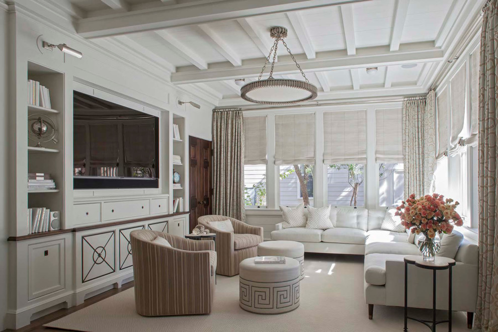 Photo of a beach style family room in Miami with white walls, no fireplace, a built-in media wall and carpet.