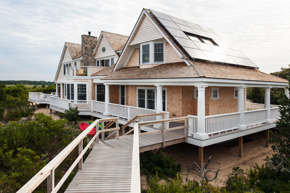 Photo of a beach style two-storey exterior in Boston with wood siding and a gable roof.