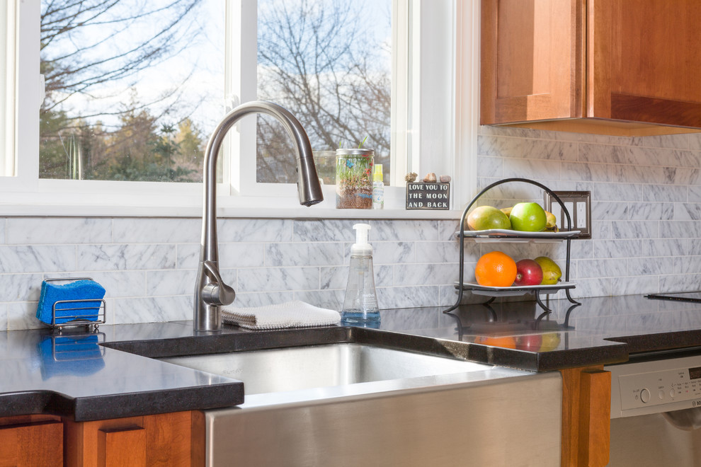 Inspiration for a mid-sized transitional u-shaped medium tone wood floor eat-in kitchen remodel in Boston with a farmhouse sink, beaded inset cabinets, medium tone wood cabinets, marble countertops, gray backsplash, marble backsplash, stainless steel appliances, a peninsula and gray countertops