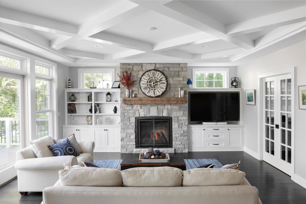 Inspiration for a large arts and crafts open concept living room in Milwaukee with grey walls, dark hardwood floors, a stone fireplace surround and brown floor.
