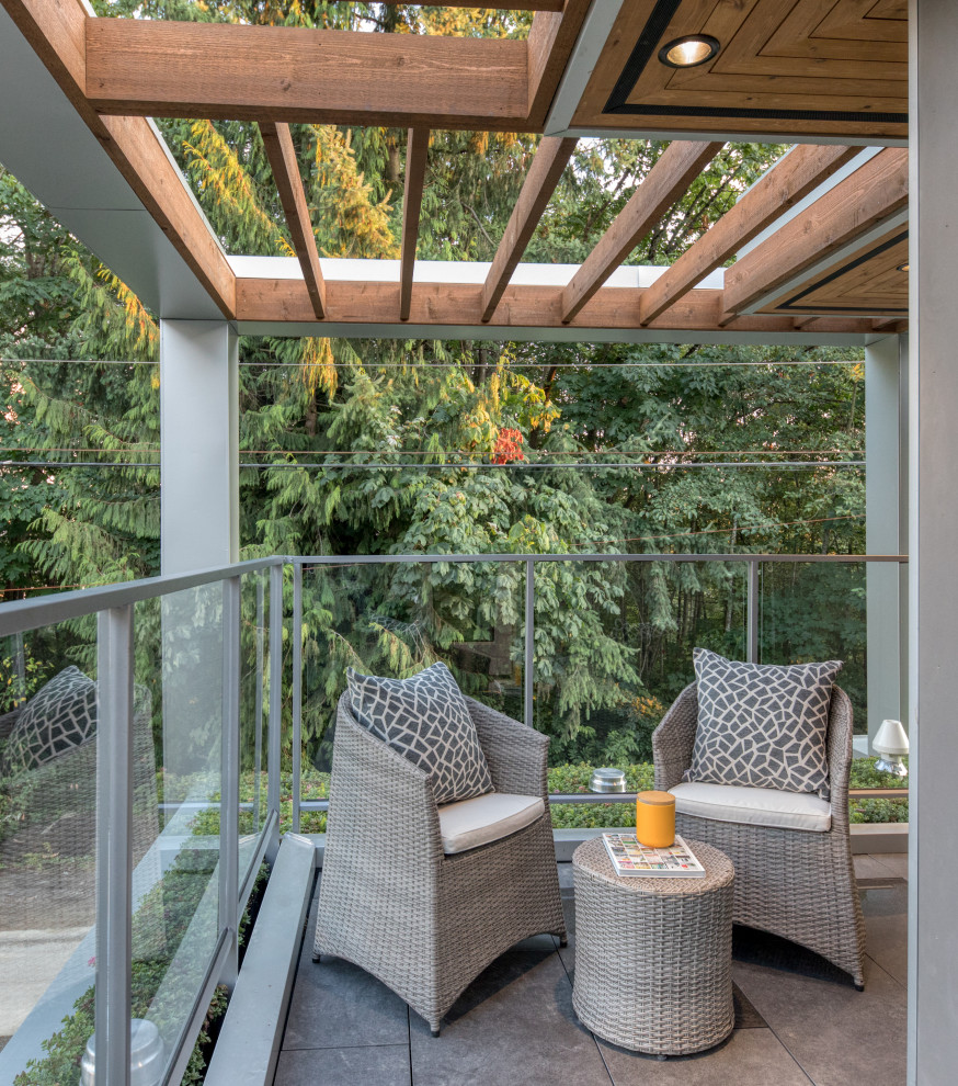 Mid-sized modern balcony in Vancouver with a pergola and mixed railing.