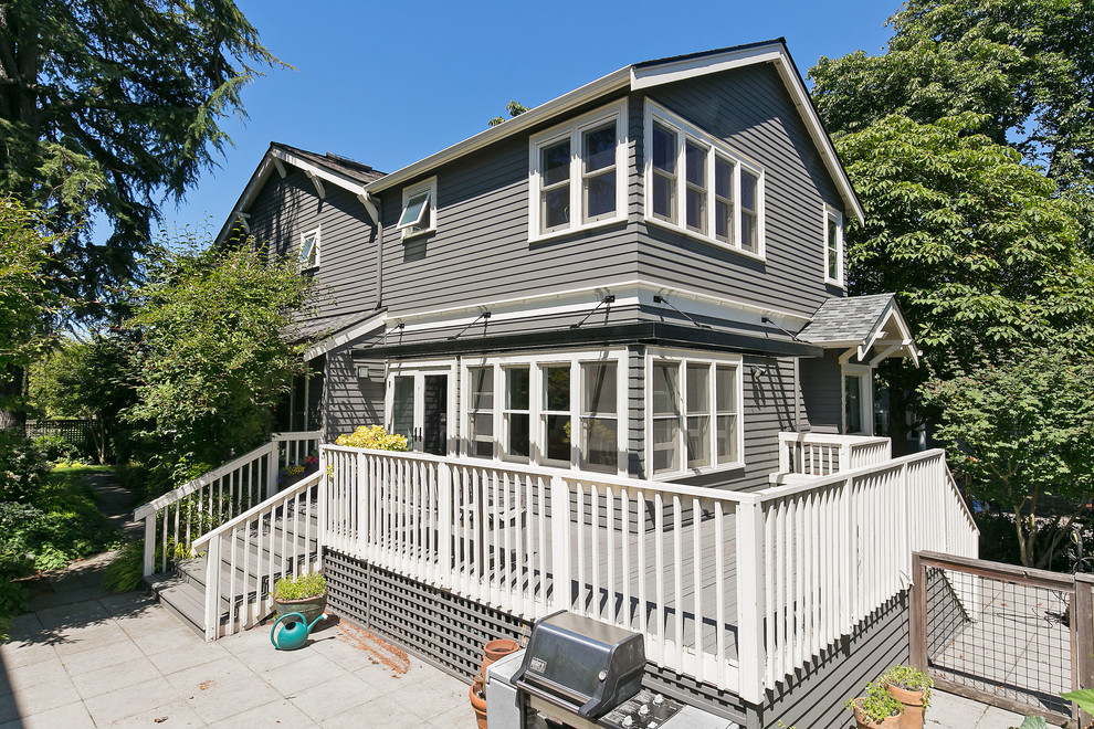 Inspiration for a mid-sized traditional three-storey grey exterior in Seattle with wood siding and a gable roof.