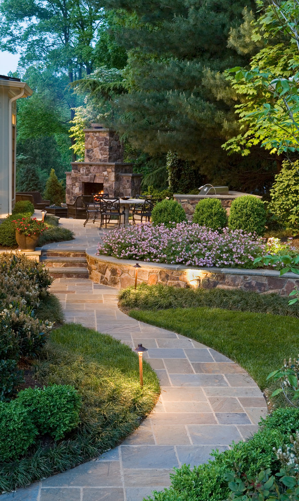 Photo of a large traditional backyard garden in DC Metro with natural stone pavers and with fireplace.
