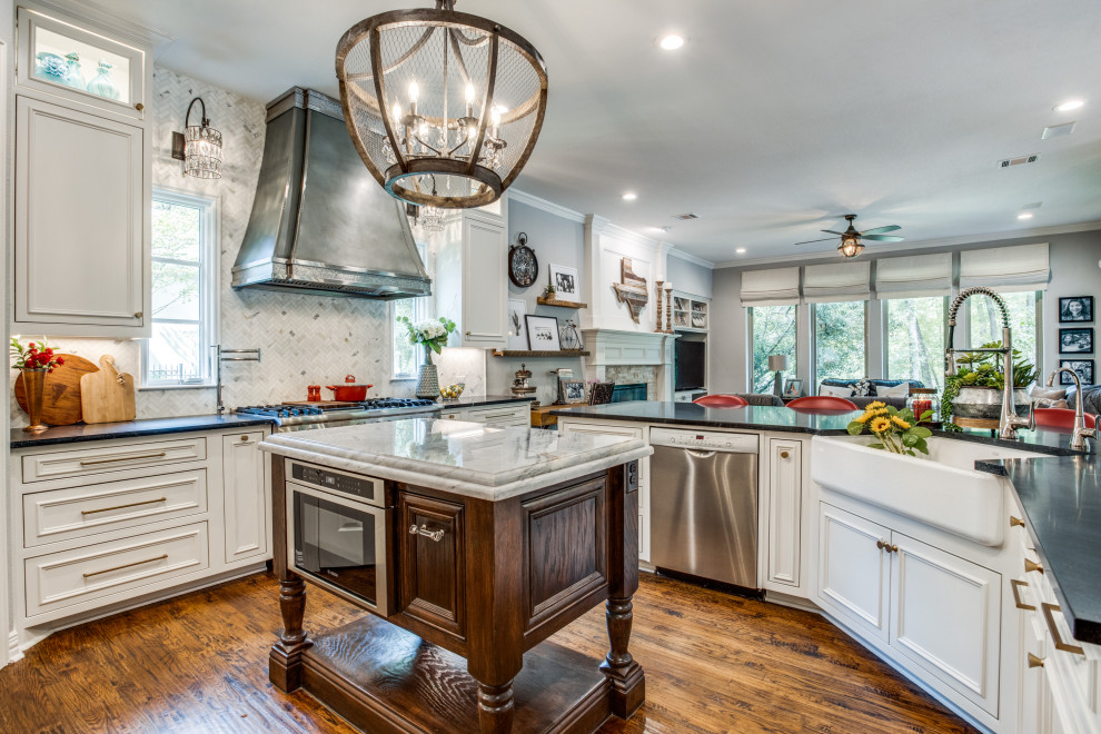 Inspiration for a mid-sized traditional u-shaped eat-in kitchen in Dallas with a farmhouse sink, white cabinets, quartzite benchtops, white splashback, marble splashback, stainless steel appliances, medium hardwood floors, with island, blue benchtop and recessed-panel cabinets.