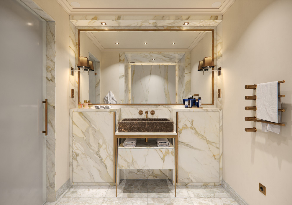 This is an example of a mid-sized contemporary master bathroom in Paris with beige cabinets, beige tile, marble, beige walls, marble floors, marble benchtops, grey floor, beige benchtops, recessed-panel cabinets, an undermount tub, a wall-mount sink, a two-piece toilet and a single vanity.