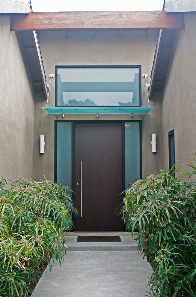 This is an example of a contemporary front door in San Diego with a single front door and a dark wood front door.