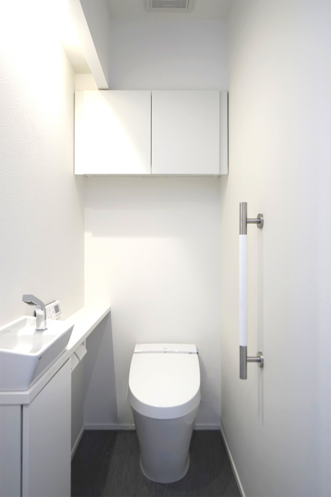 This is an example of a mid-sized modern powder room in Other with white walls, grey floor, wallpaper and wallpaper.