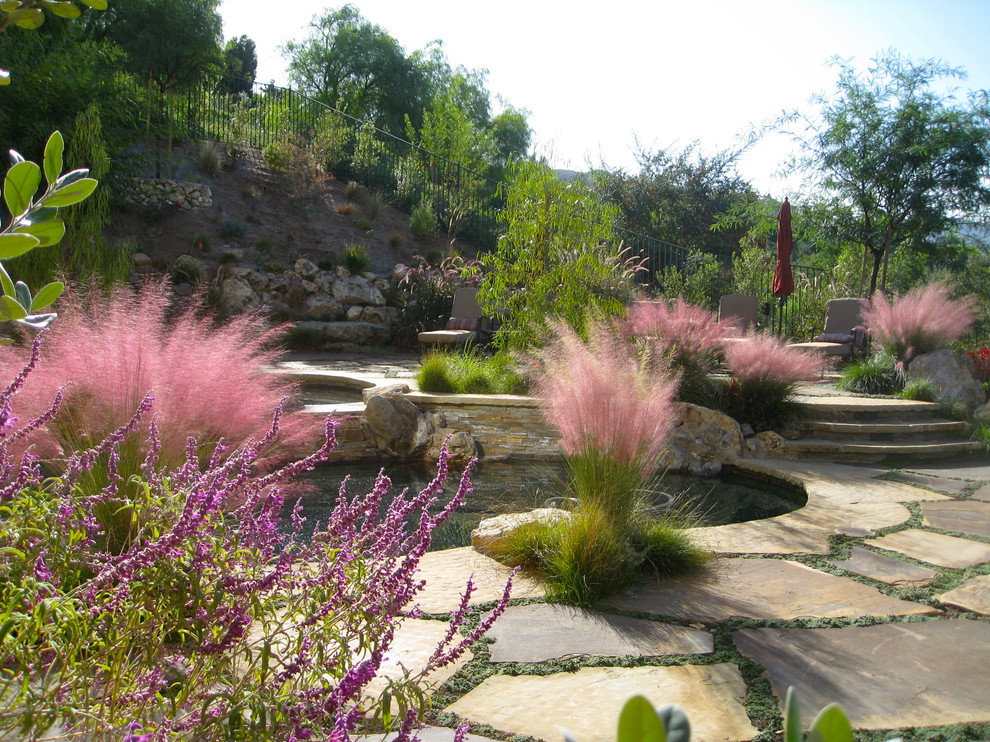 Mediterranean garden in Los Angeles with a retaining wall.