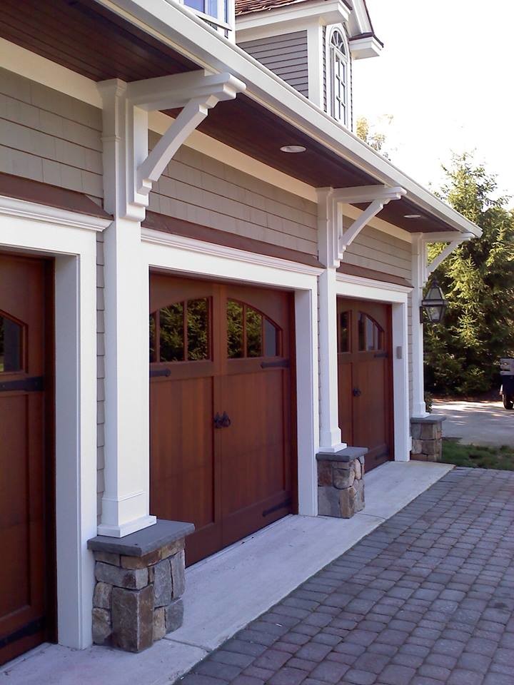 Garage - mid-sized craftsman attached three-car garage idea in New York