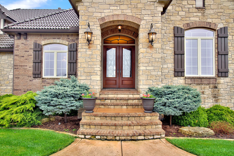 Design ideas for a mid-sized mediterranean front door in Wichita with beige walls, a double front door, a red front door and beige floor.