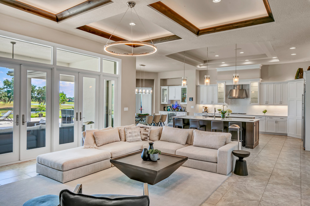 Large modern open concept family room in Tampa with grey walls, travertine floors, a built-in media wall, multi-coloured floor and recessed.