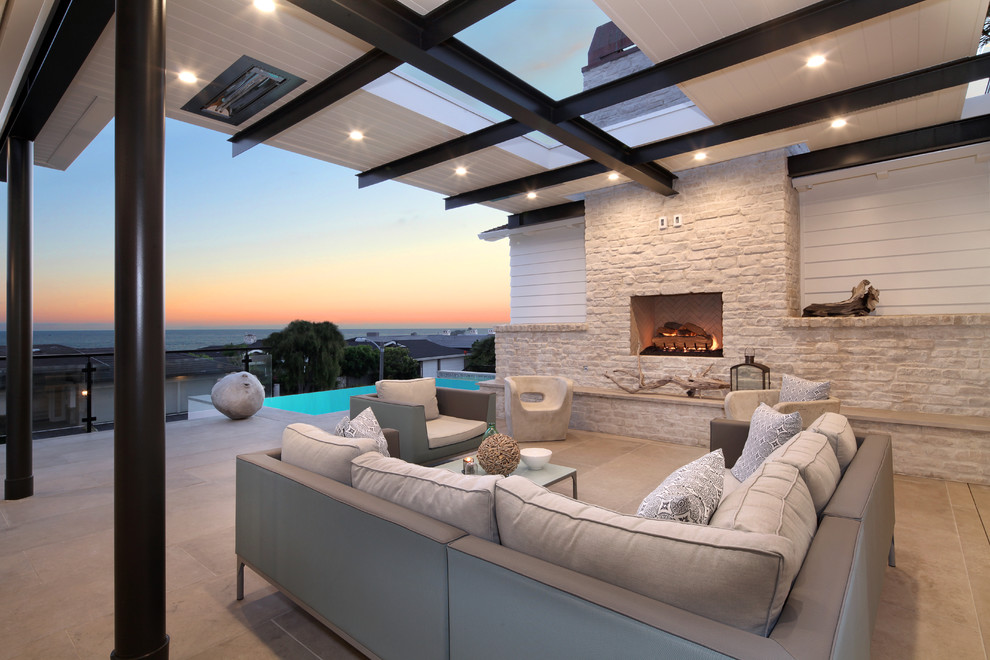 Design ideas for a contemporary patio in Orange County with a pergola and with fireplace.